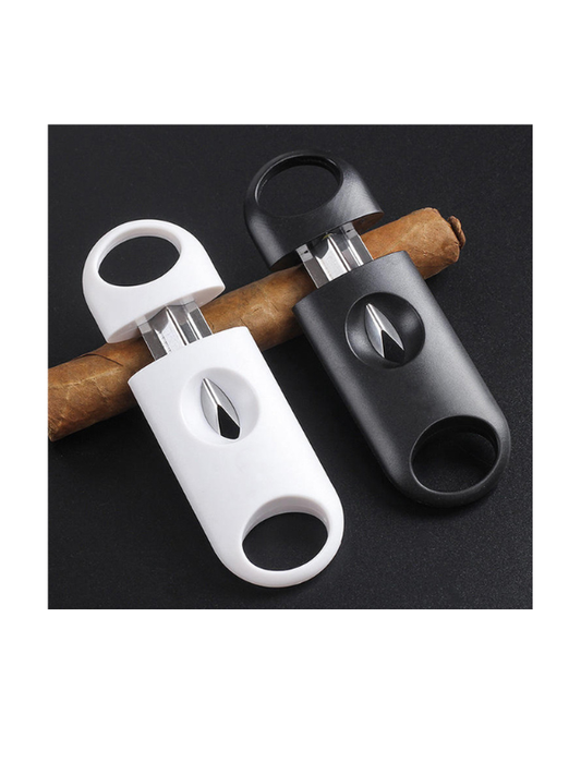 Two cigar cutters, one white and one black, on a black background with cigars.Vape dokha