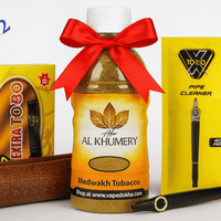 Al Khumery Dokha tobacco bottle with a red bow, Extra Toro packaging, and vape device on a white background. blue 2 vape dokha