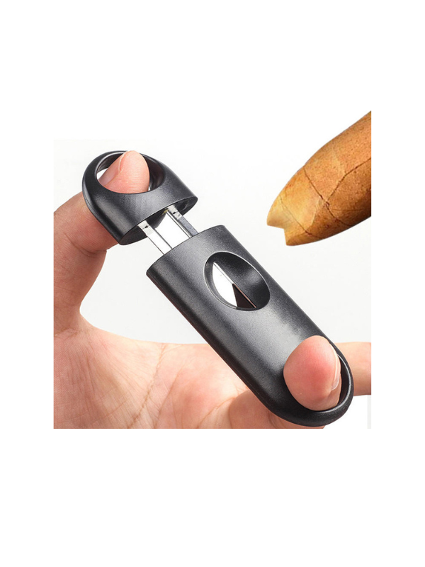 Hand holding a black cigar cutter with a can on a white background. Vape Dokha