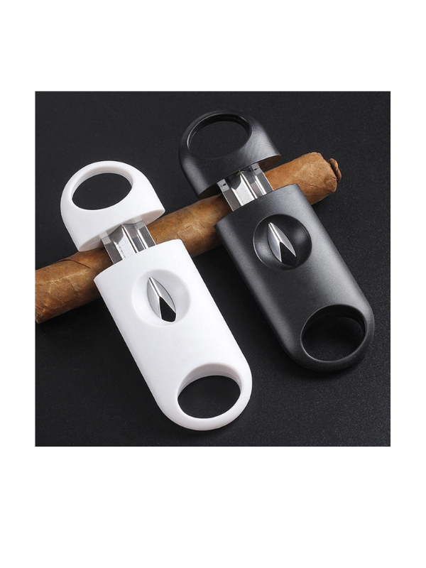 Two cigar cutters, one white and one black, on a black background with cigars.Vape dokha 